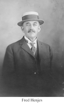 Fred Henjes wearing a coat, tie, and a brimmed hat